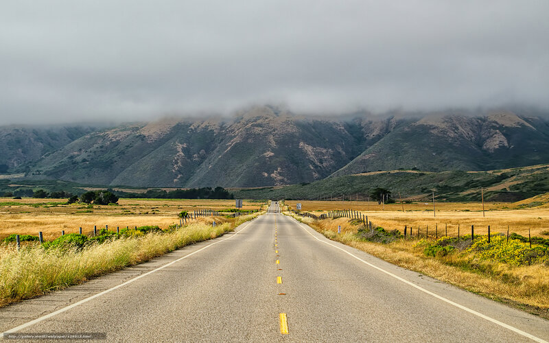 Road leading to foggy mountains