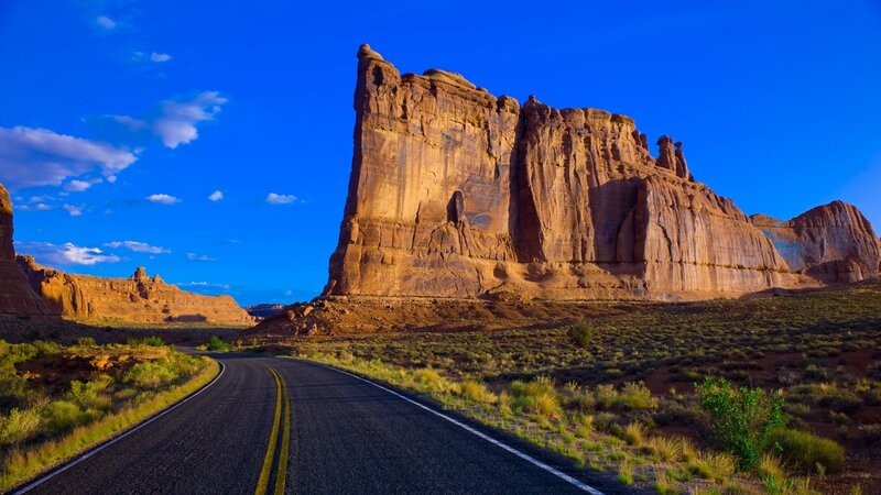 Road Leading to Rock Formation — Blue, Serene, Afternoon, Photograph