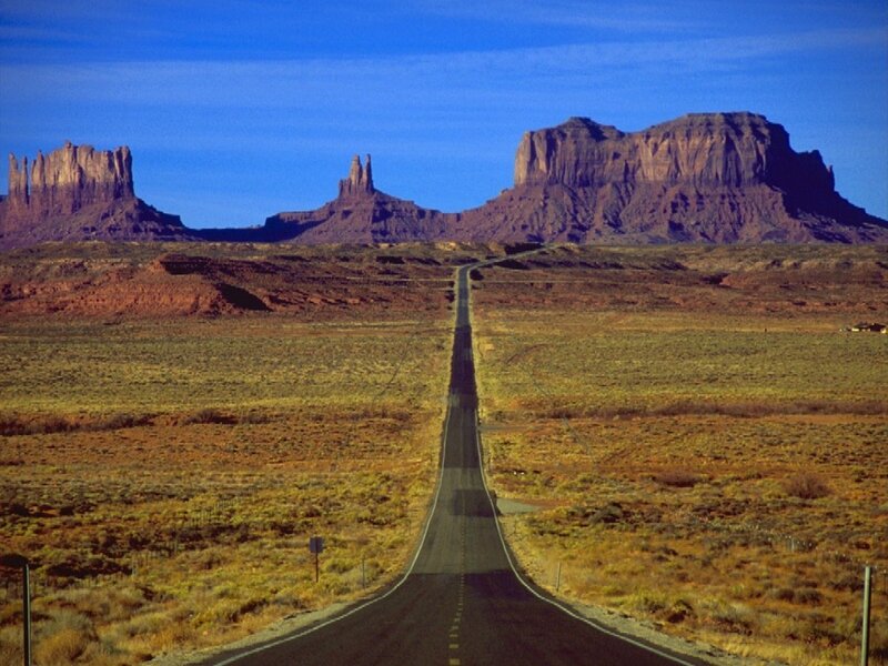 Road Leading to Rock Formations — Blue, Serene, Afternoon, Photograph, Desert