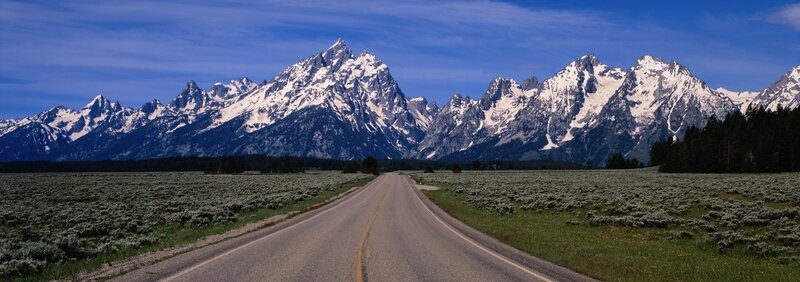 road leading to snow-capped mountains