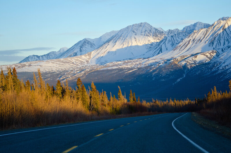 Road leading to snow-capped mountains