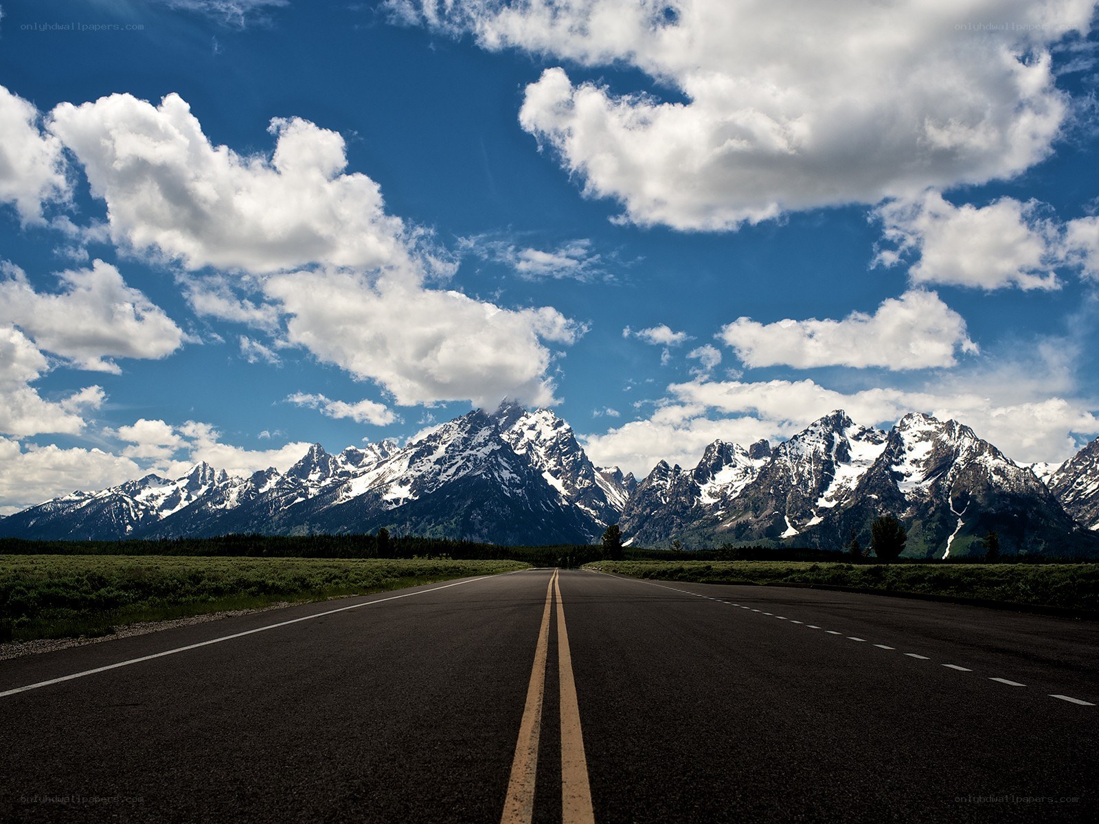 Road leading to snow-capped mountains