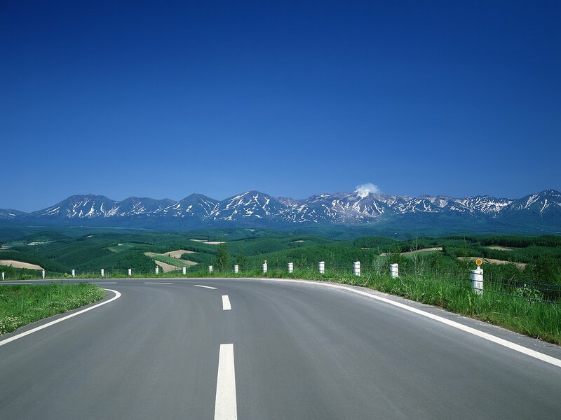 Road leading to snow-capped mountains