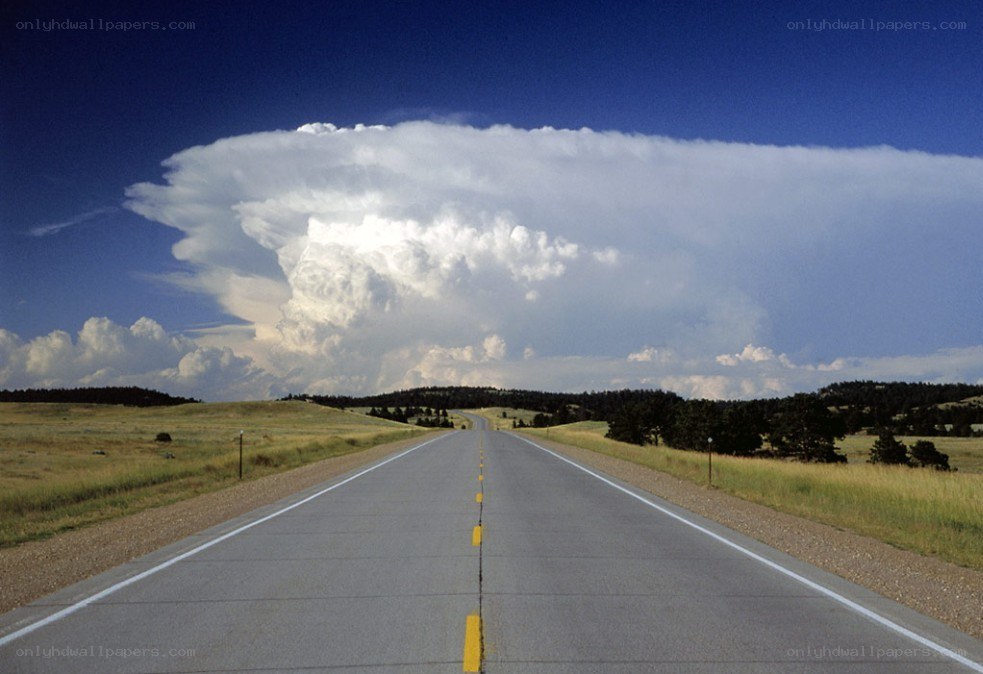 Road leading to storm cloud
