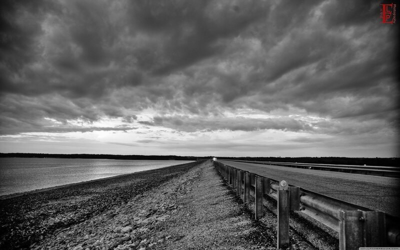 Road over a reservoir at dusk