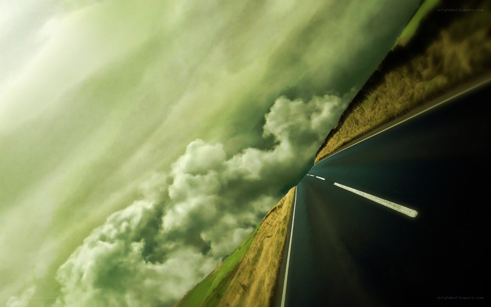 Road stretching into stormy sky