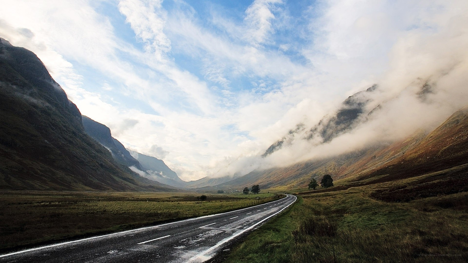 Road through a misty mountain valley