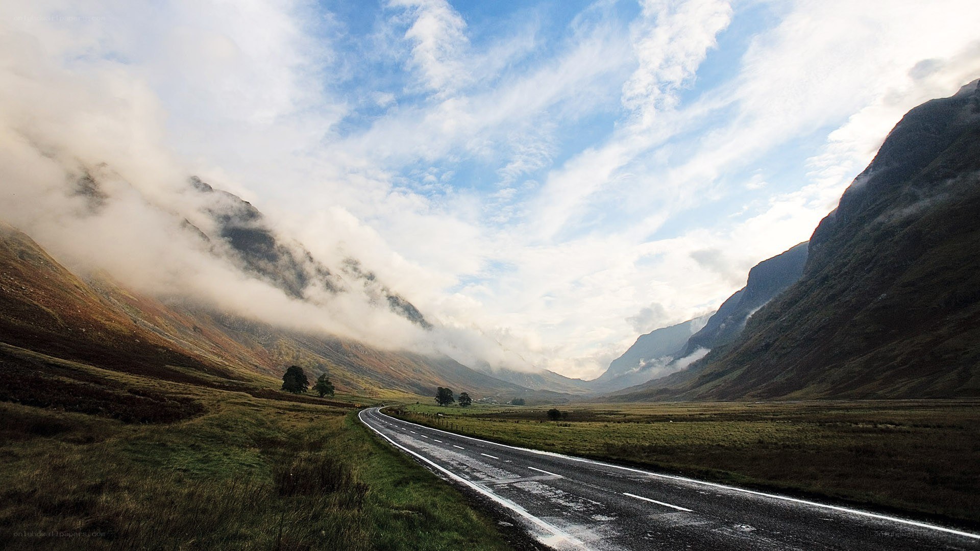 Road through misty mountain valley