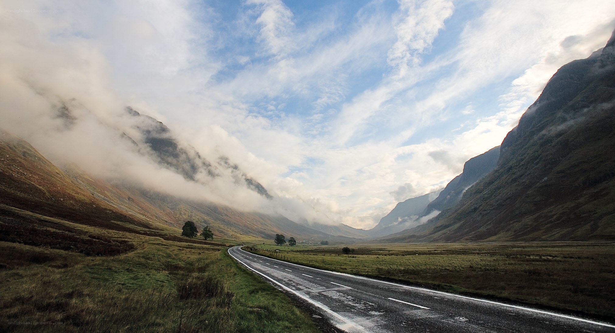 Road through misty mountain valley