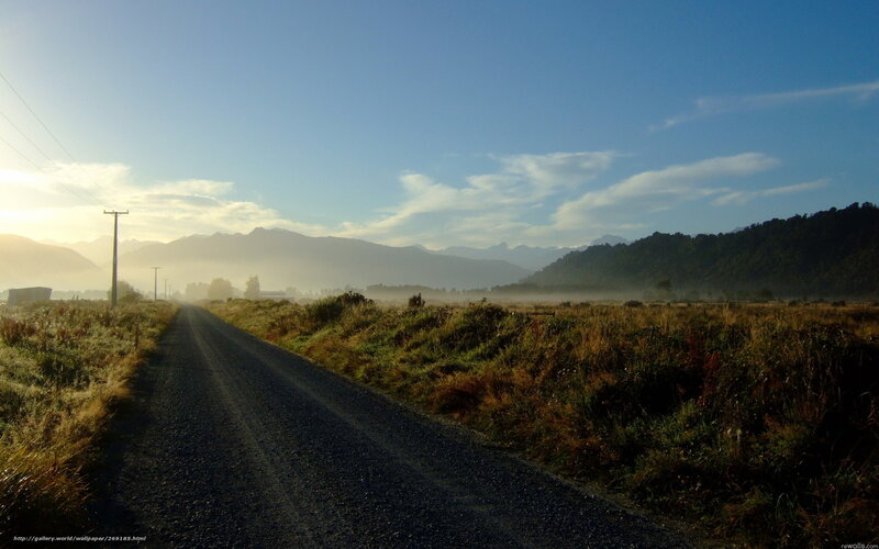 Road through misty valley