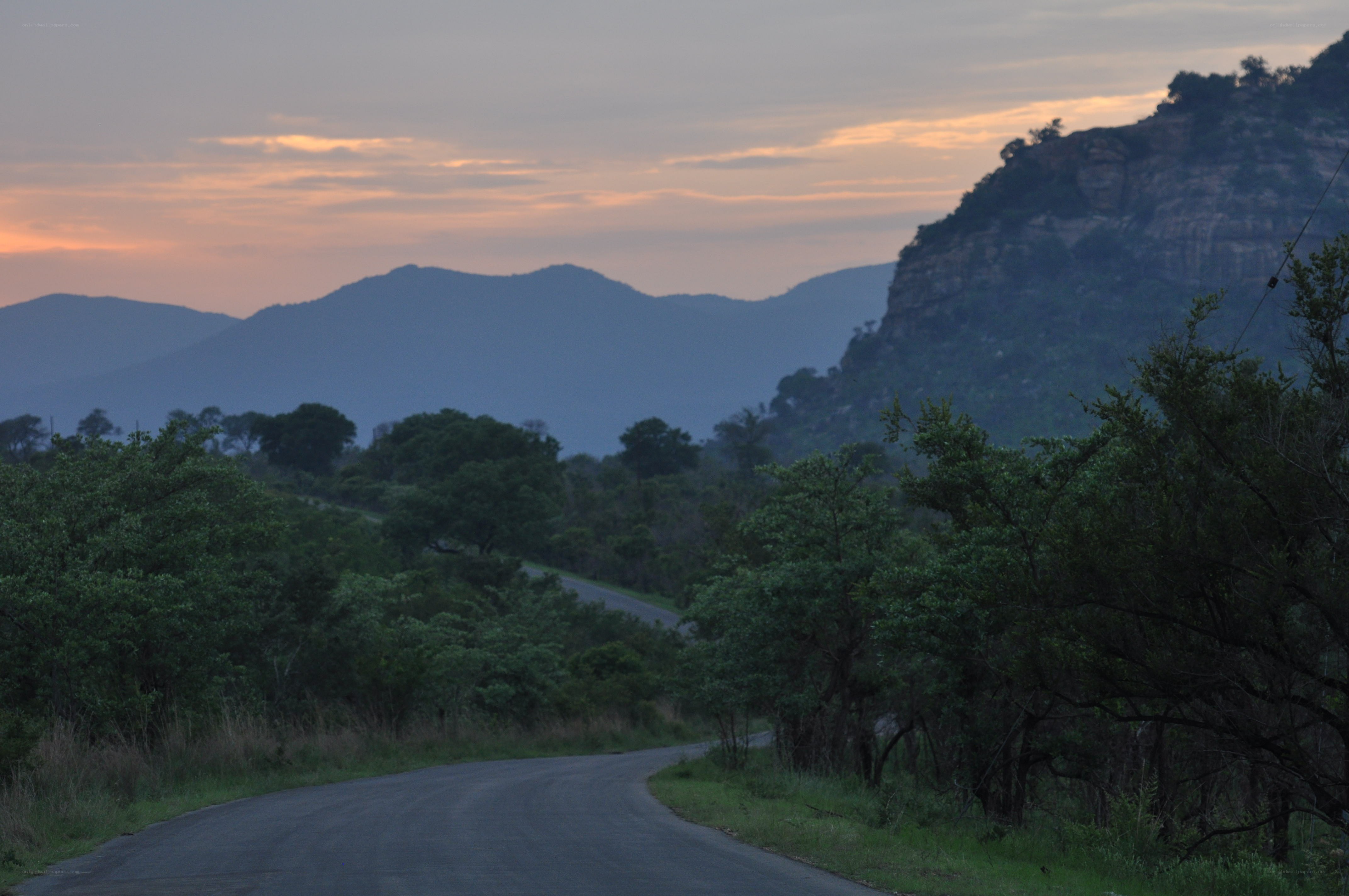 Road through mountain valley at dusk