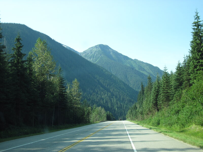 Road Through Mountain Valley — Green, Serene, Afternoon, Photograph, Mountains