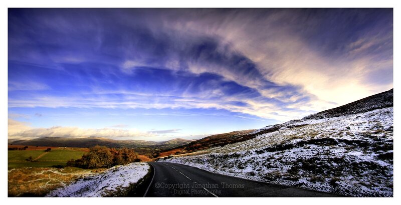 Road through snowy hills