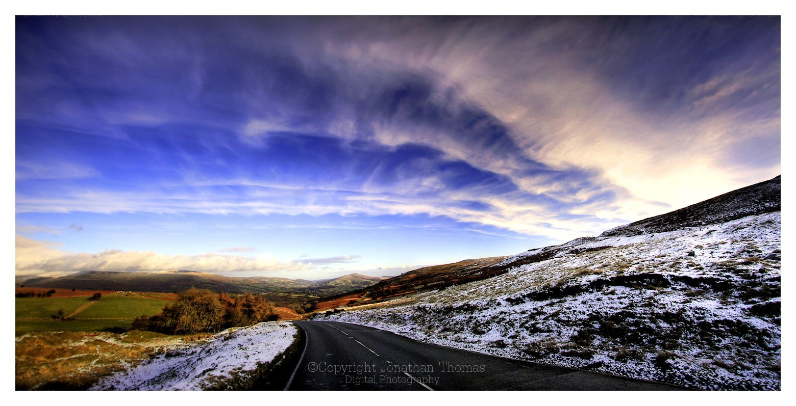 Road through snowy hills