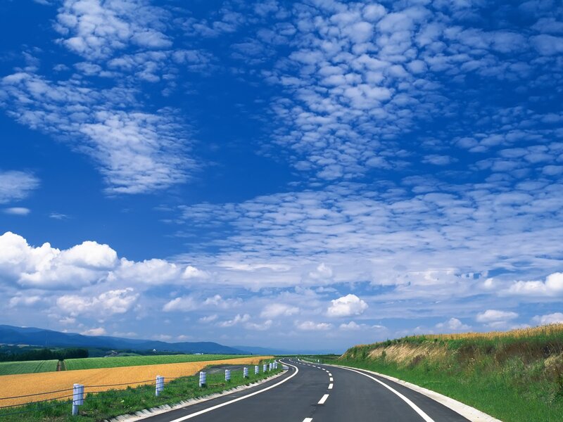 Road under blue sky with clouds