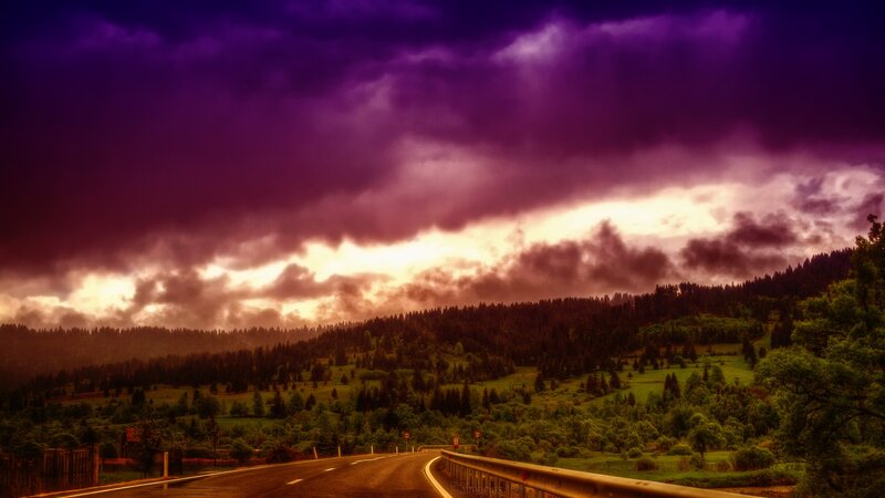 Road under purple storm clouds
