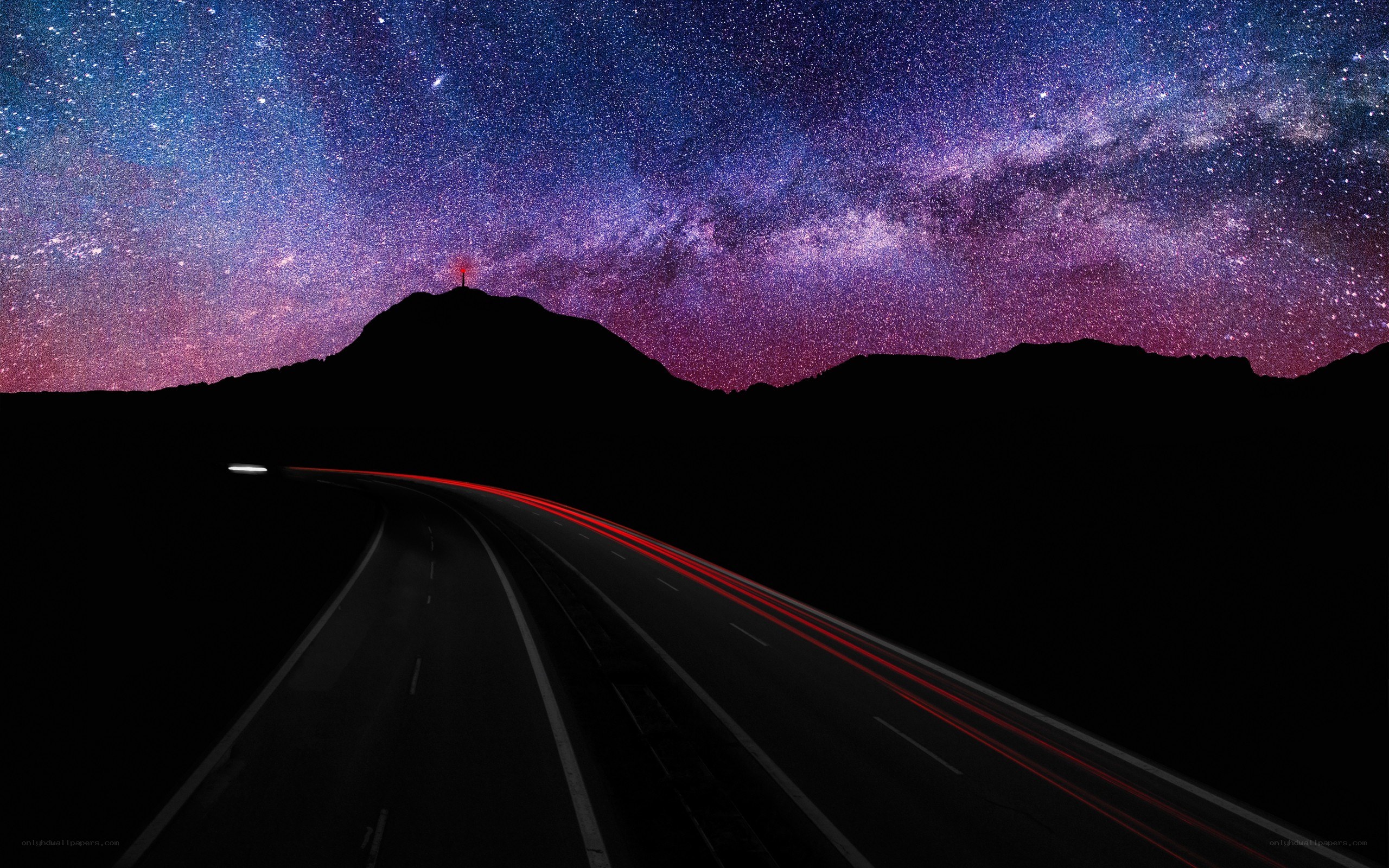Road under starry night sky