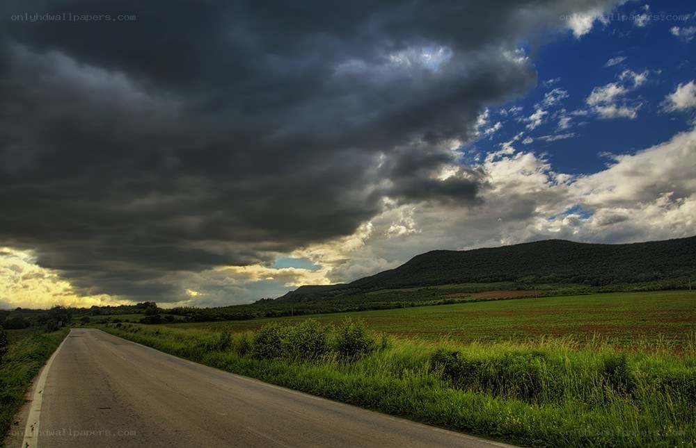 Road under stormy sky