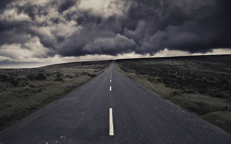 Road under stormy sky