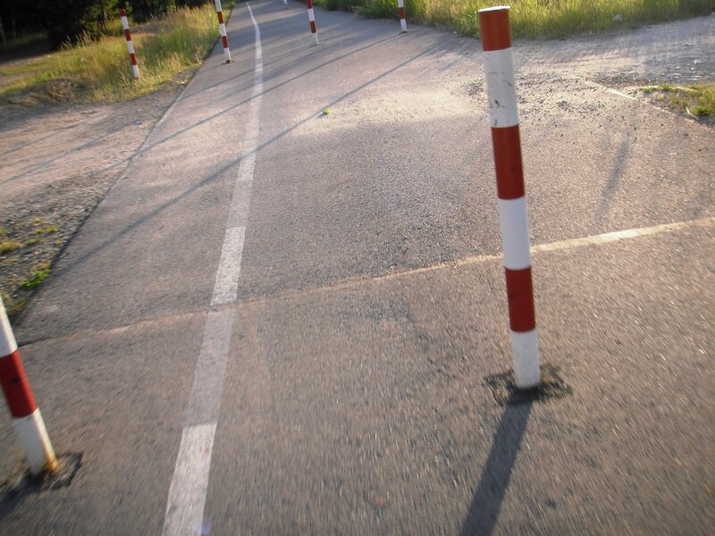 Road with bollards and white line