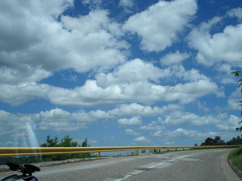 Road with clouds and guardrail