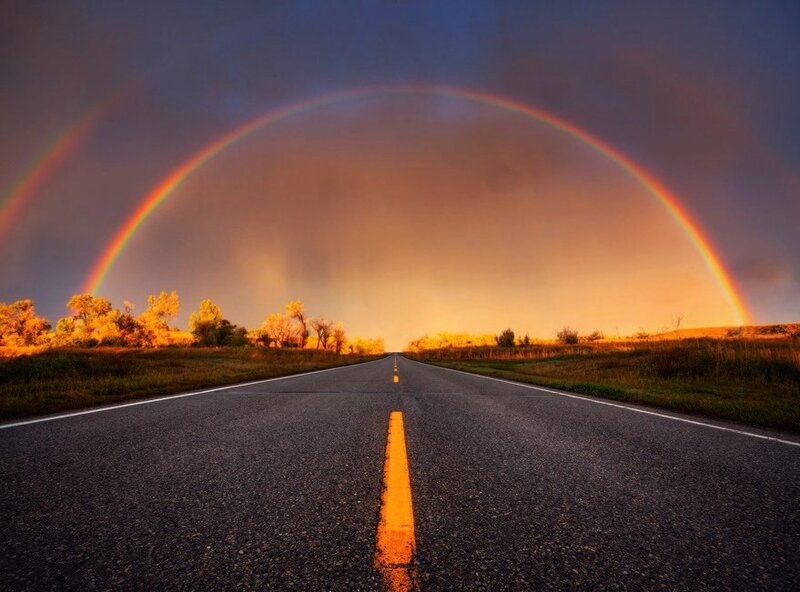 Road with double rainbow