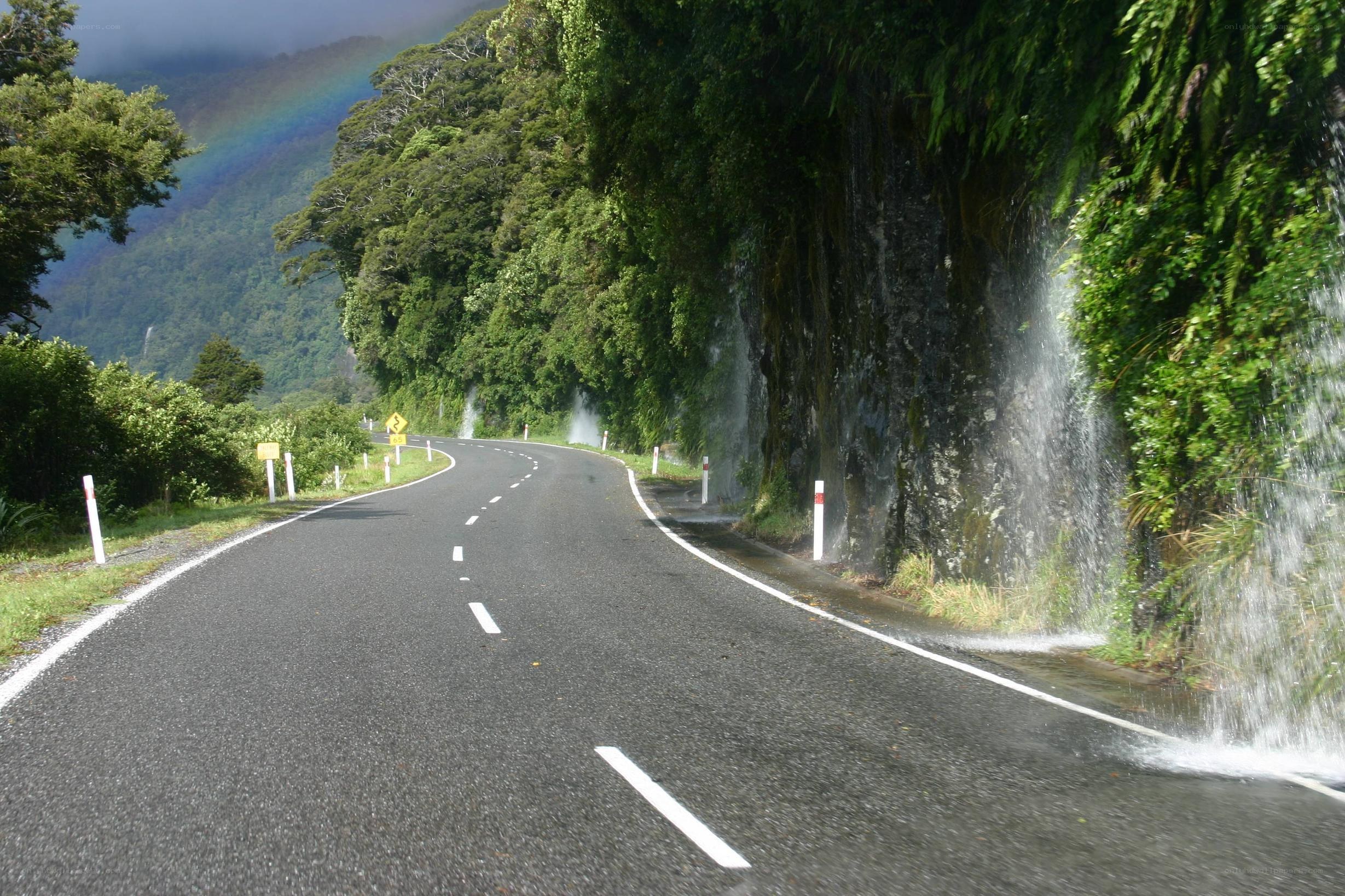 Road with waterfall and rainbow