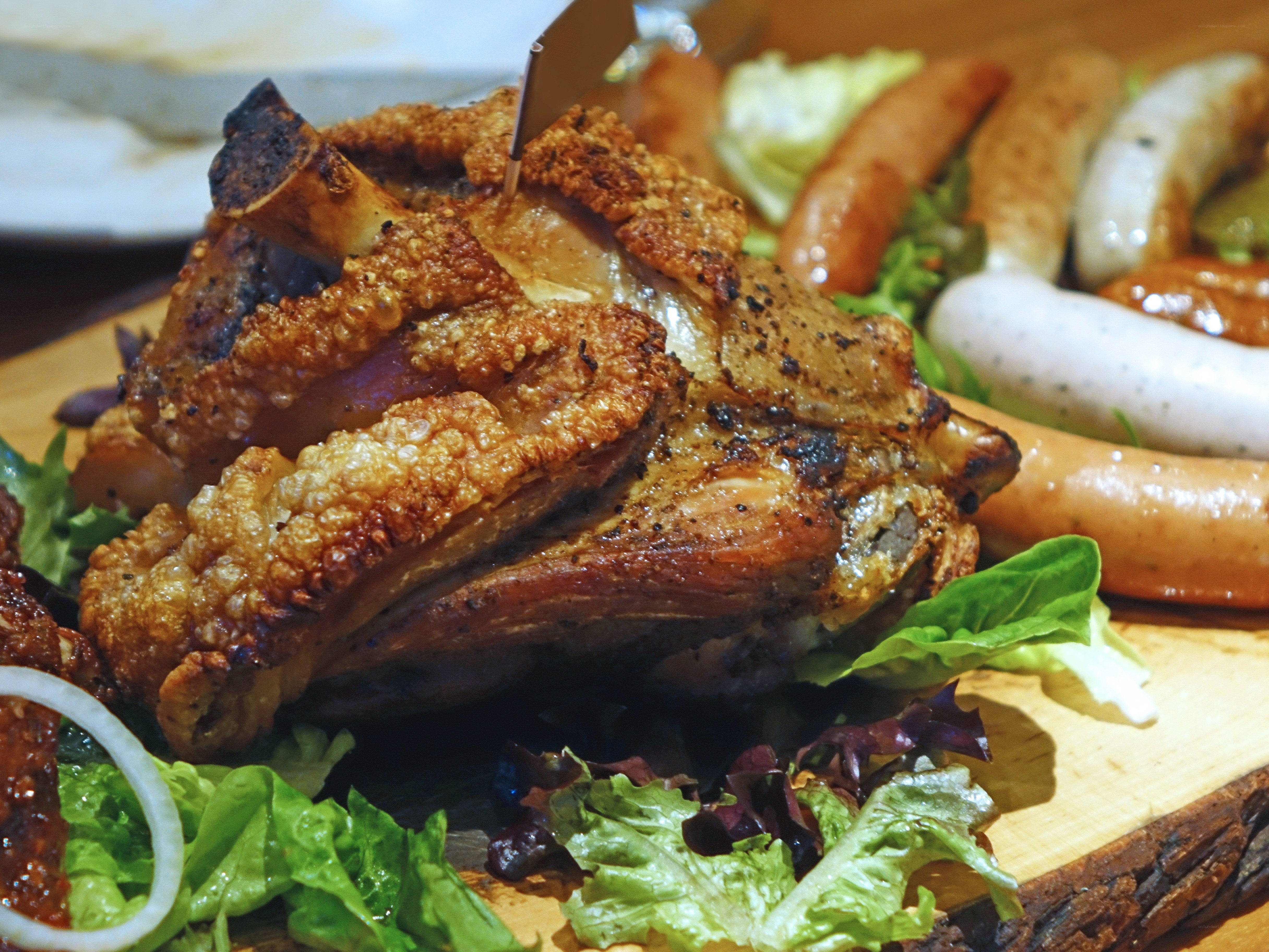 Roasted pork knuckle with sausages