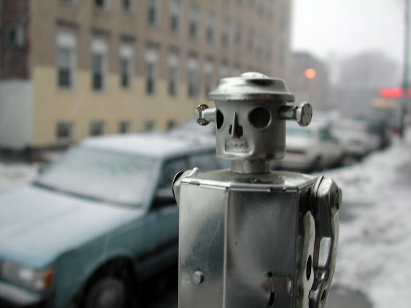 robot figurine on snowy street