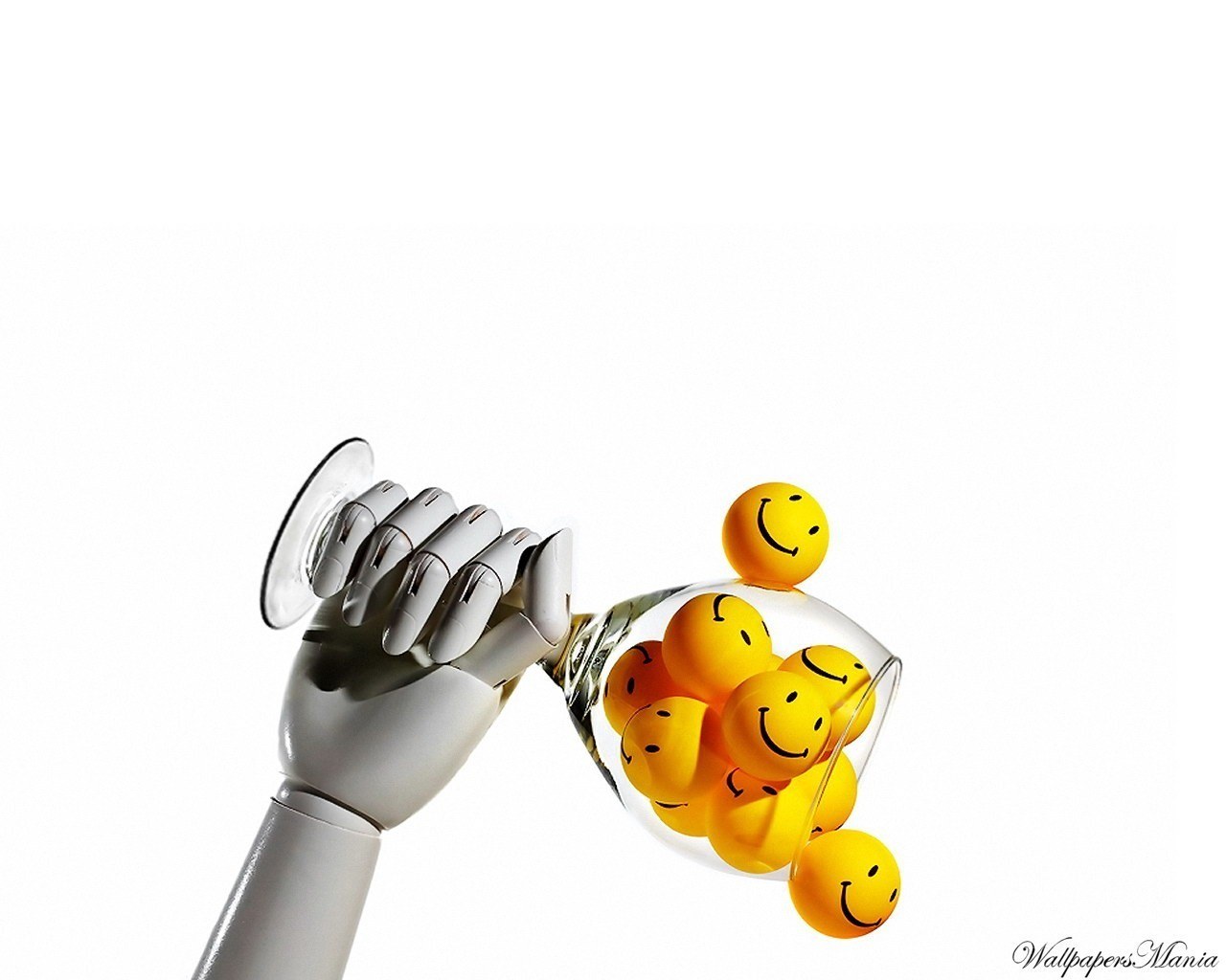 robot hand holding smiley balls
