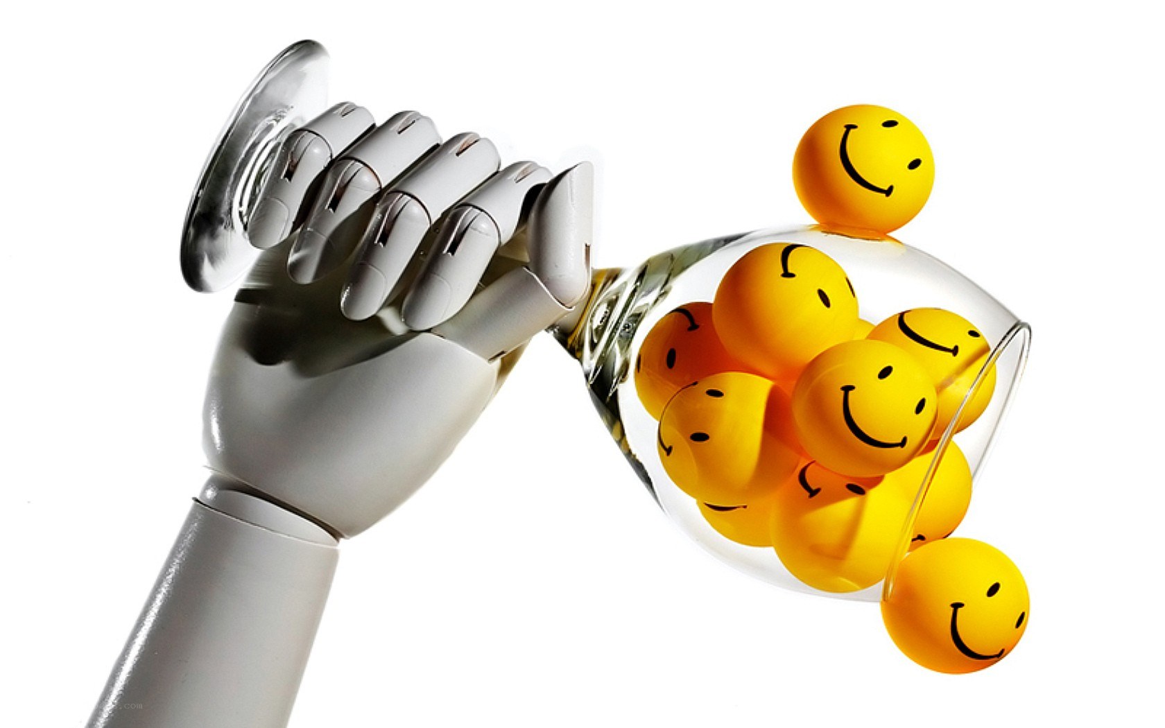robot hand holding smiley balls