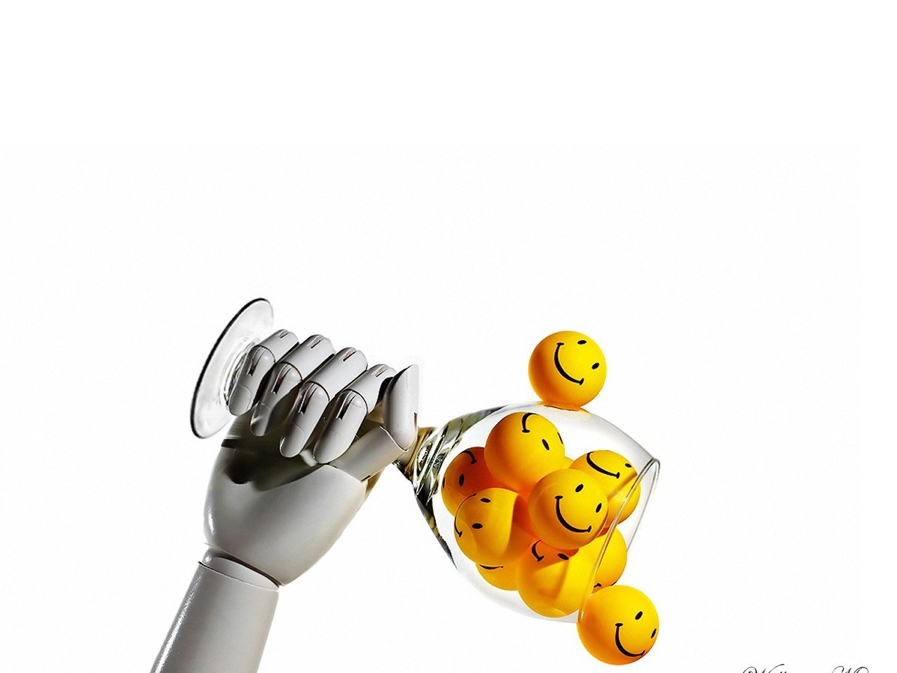 robot hand pouring smiley balls