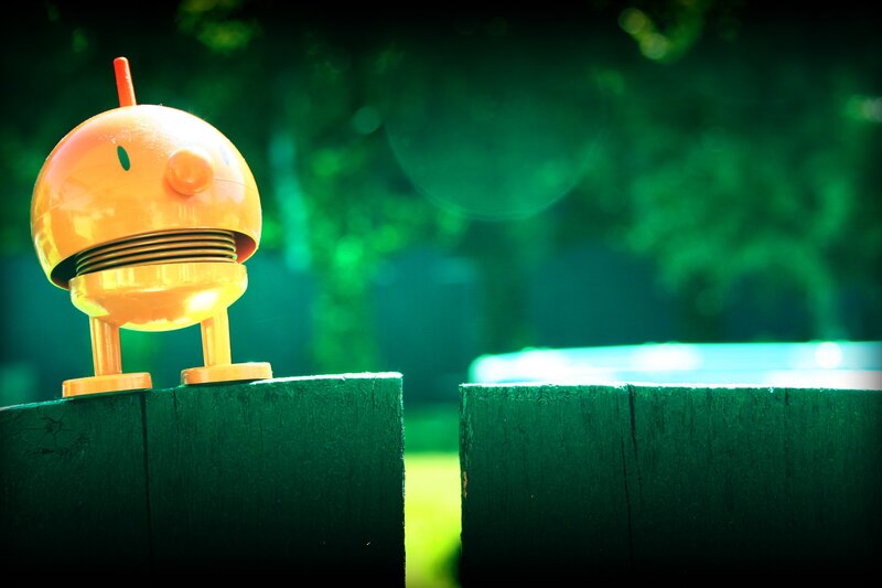 robot on a wooden post