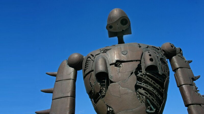 robot statue against blue sky