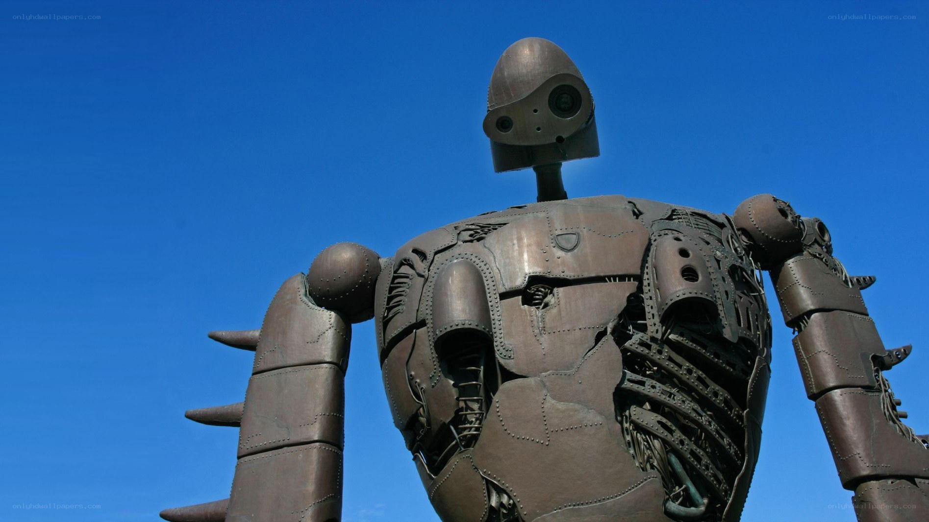 robot statue against blue sky