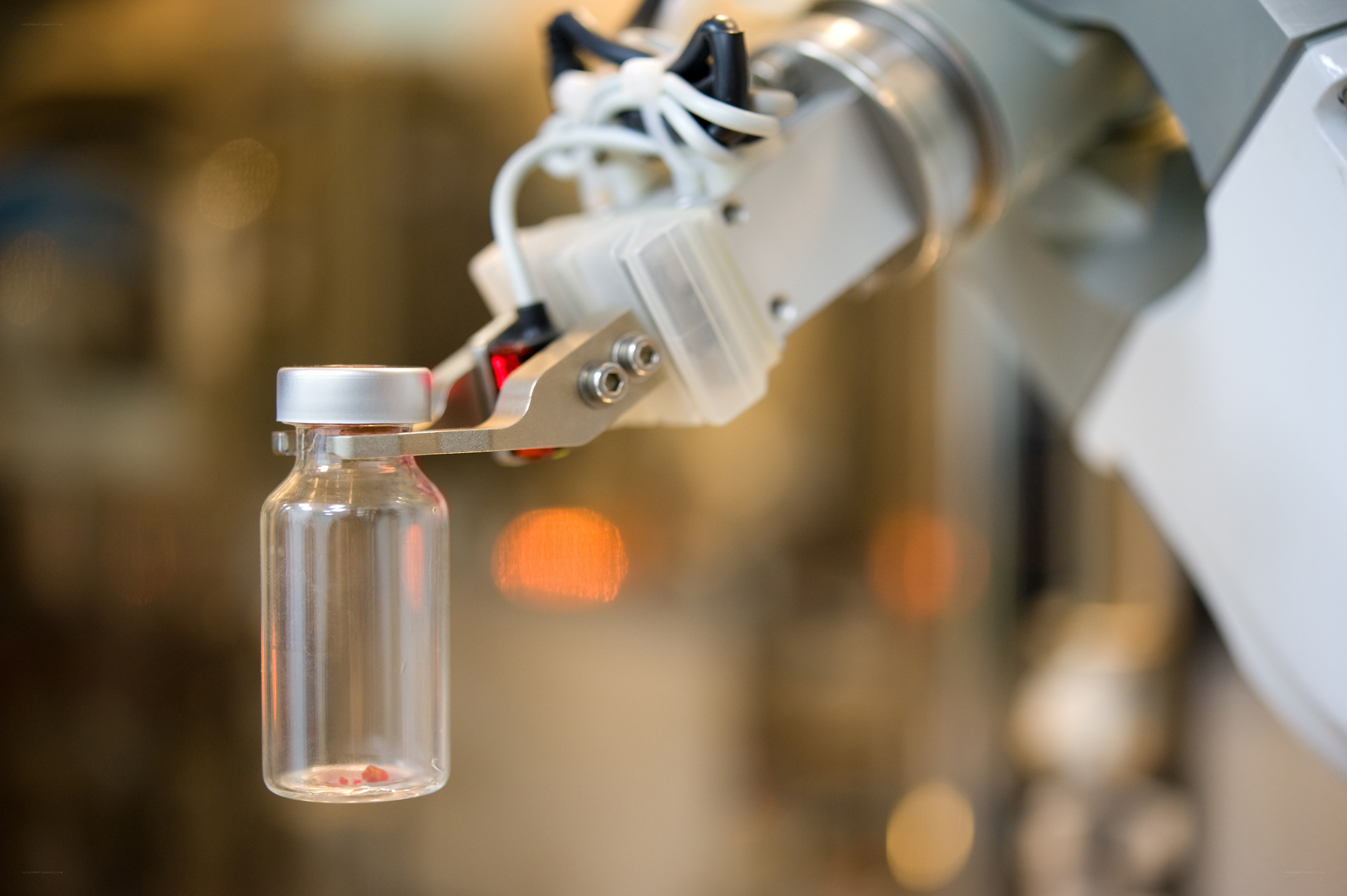 robotic arm holding vial