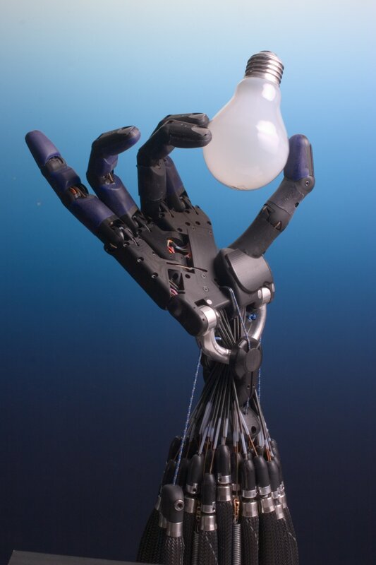 robotic hand holding light bulb
