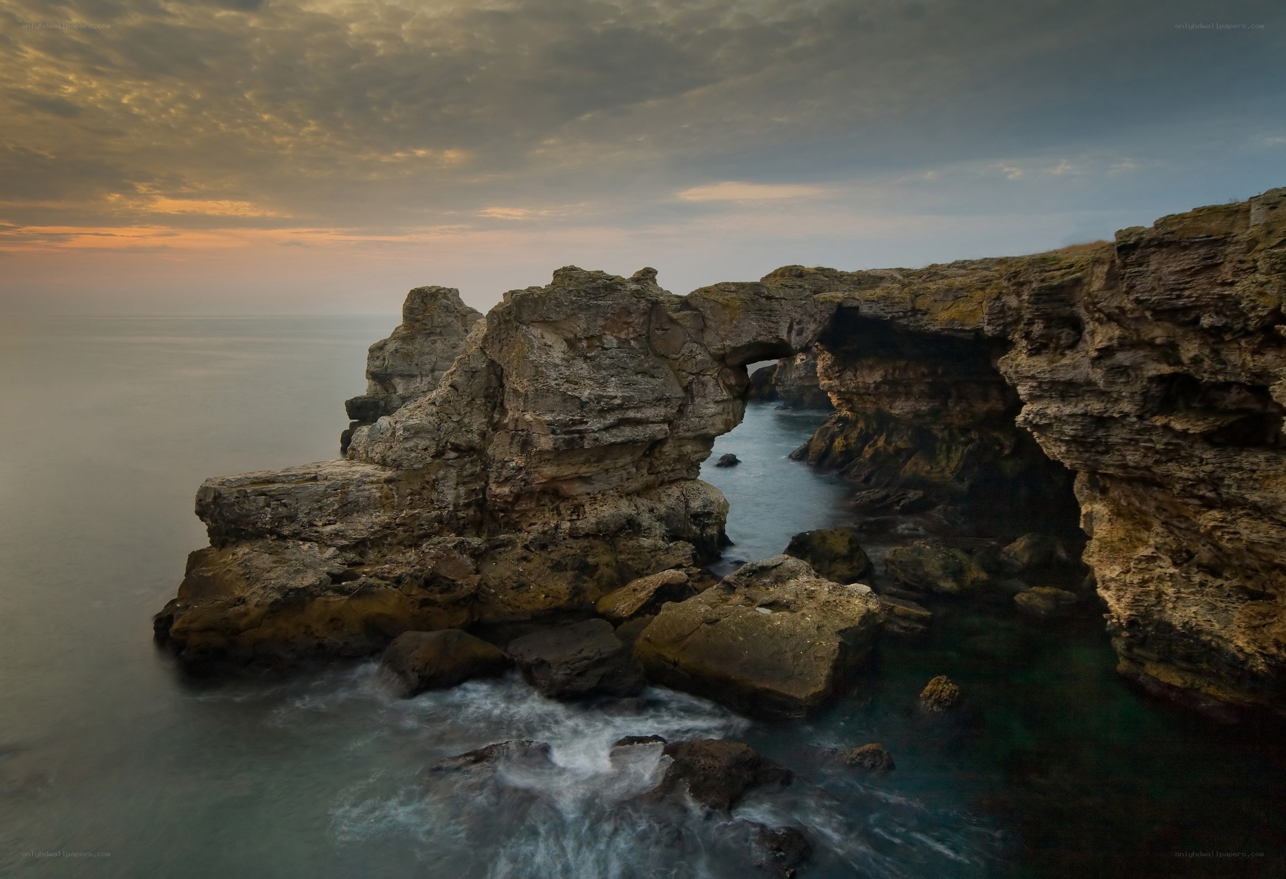 Rock arch at coastal sunset