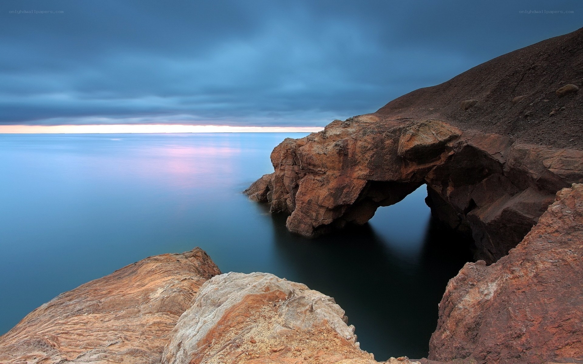 Rock arch at coastal sunset