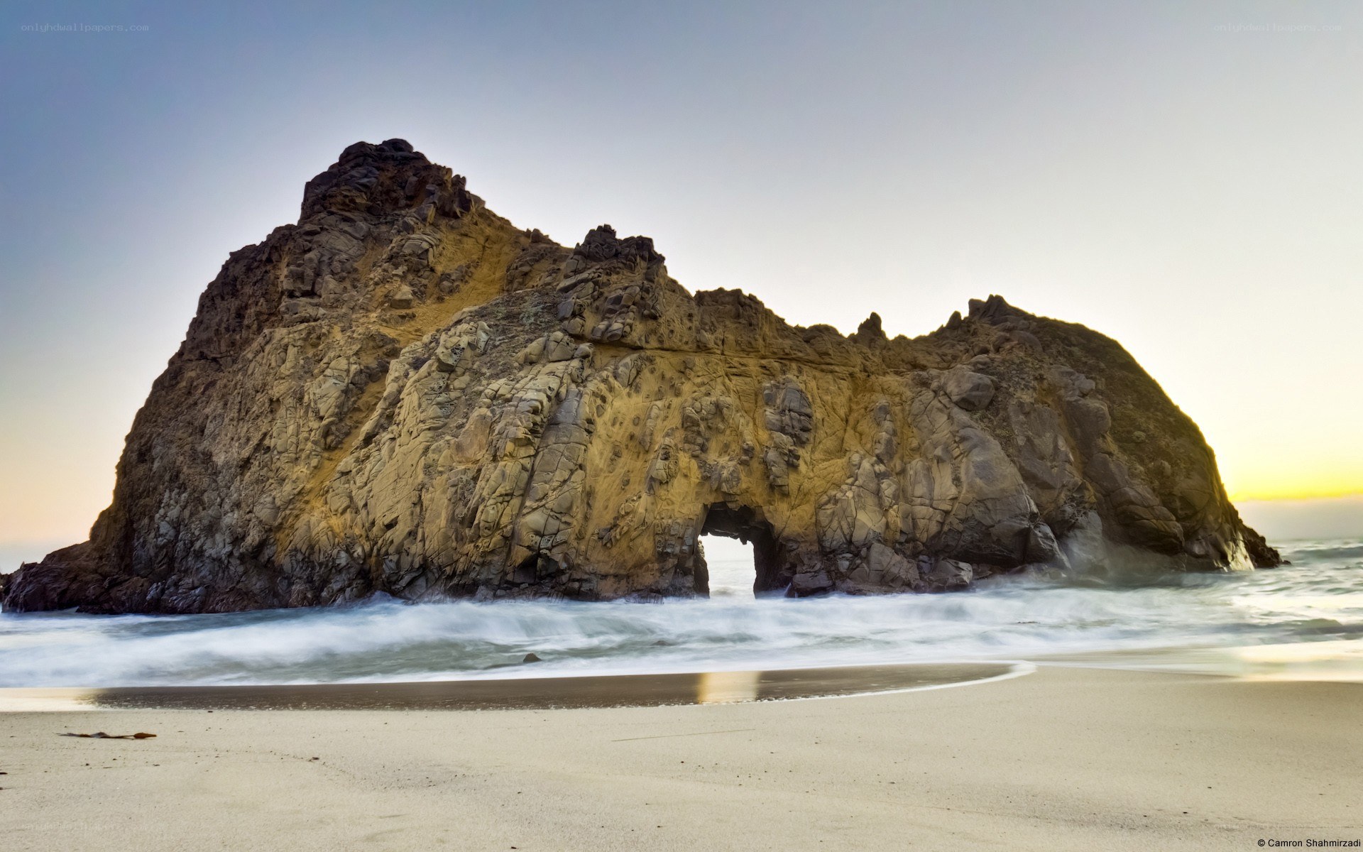 Rock arch at sunset on beach