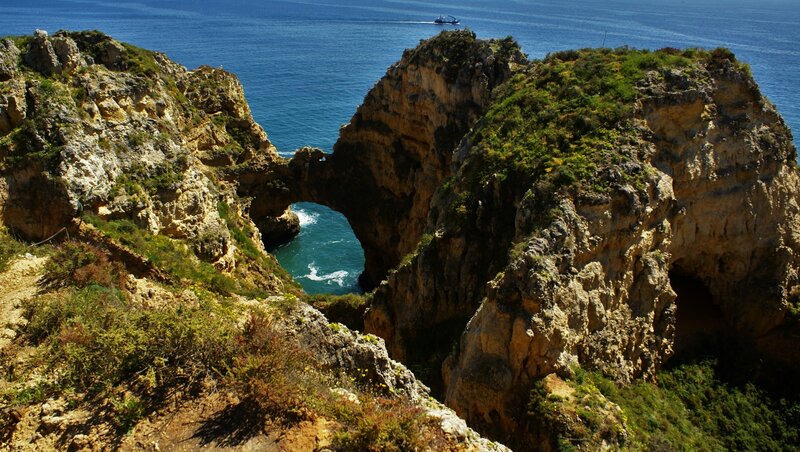 Rock Arch Formation — Blue, Serene, Afternoon, Photograph, Ocean, Boat