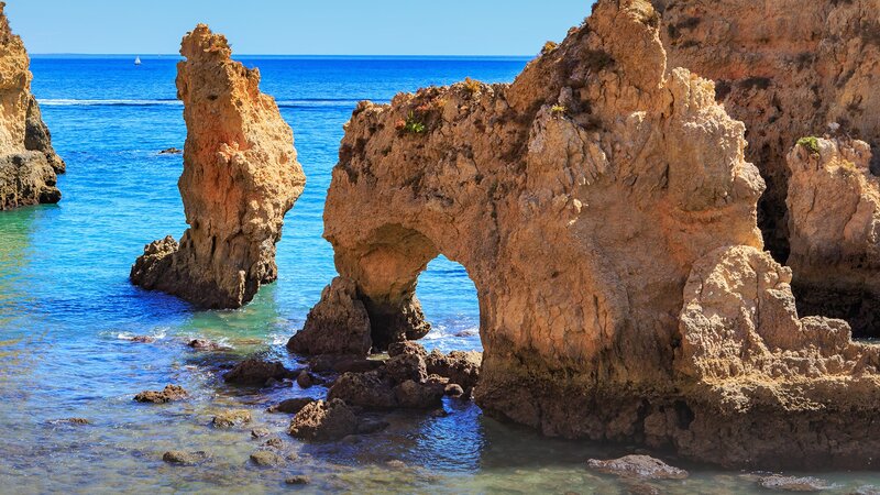 Rock Arch Formation — Blue, Serene, Afternoon, Photograph, Ocean, Sailboat