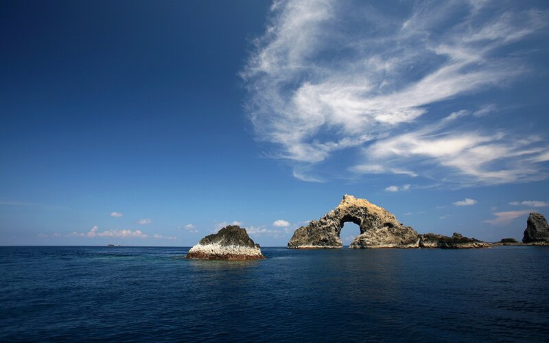 Rock Arch Formation — Blue, Serene, Afternoon, Photograph, Ocean, Sky, Clouds, White, Gray