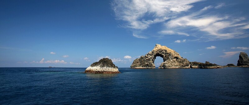 Rock Arch Formation — Blue, Serene, Afternoon, Photograph, Sea, Sky, Clouds