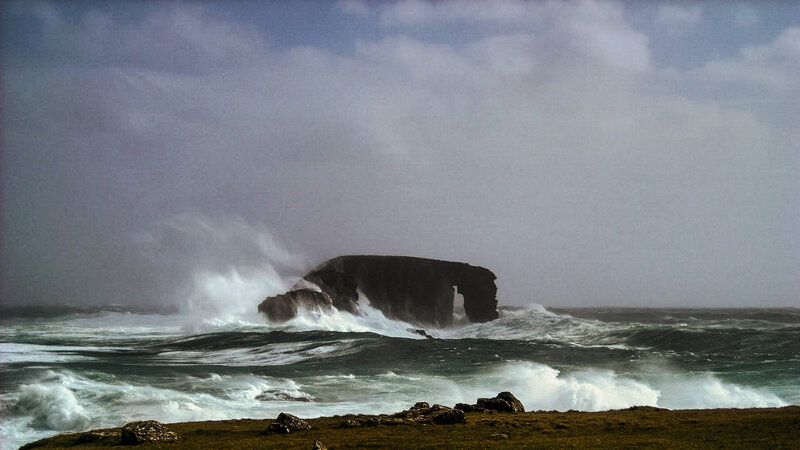 Rock Arch in Stormy Sea