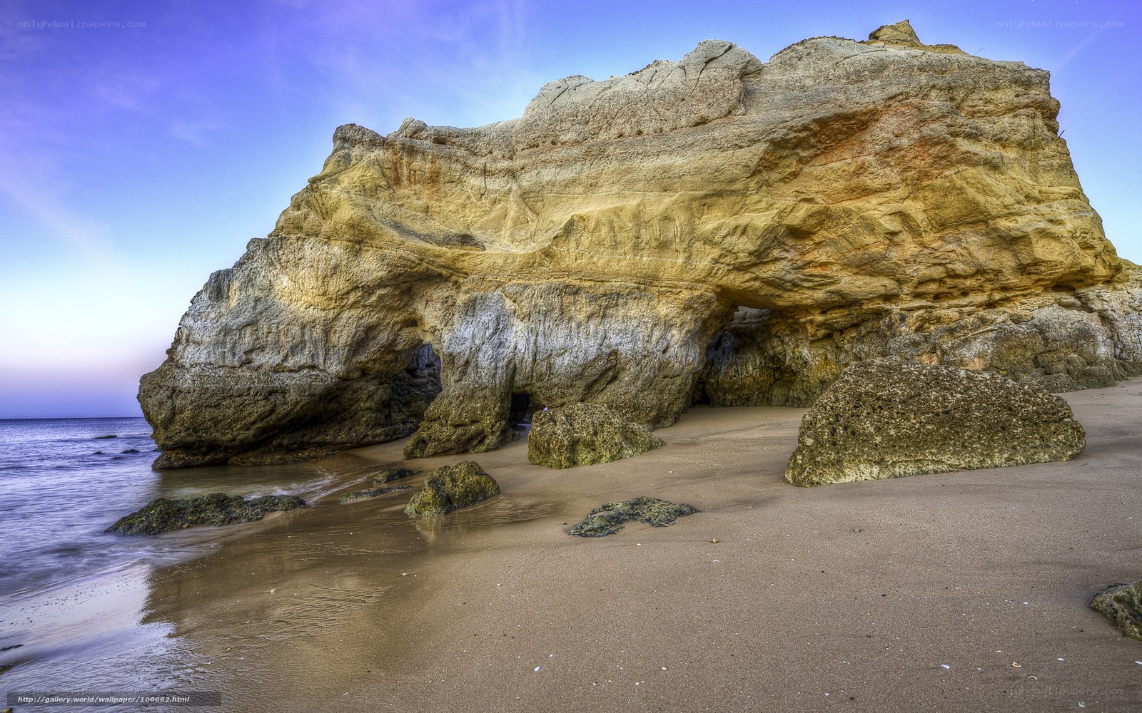 Rock arch on sandy beach
