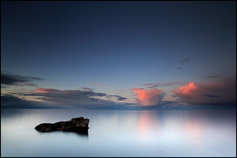 Rock at dusk by the sea