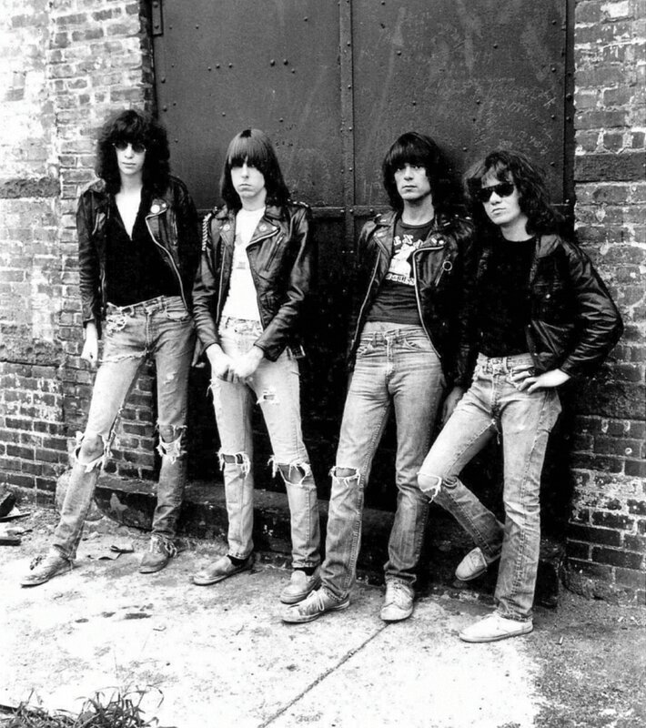 rock band posing against a brick wall