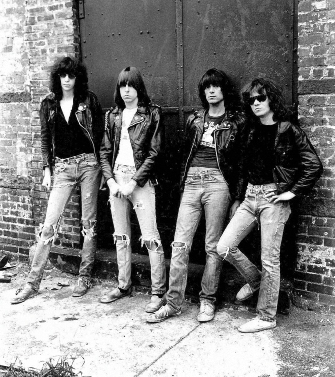rock band posing against a brick wall