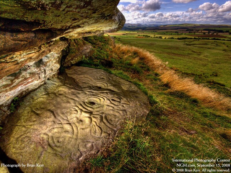 Rock carvings in a scenic landscape